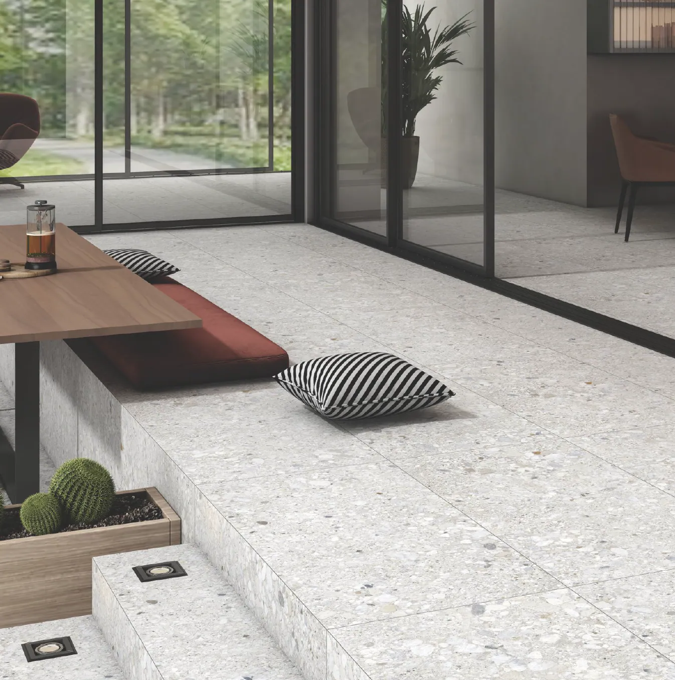 Terrazzo-look porcelain floor tile beside a modern glass wall